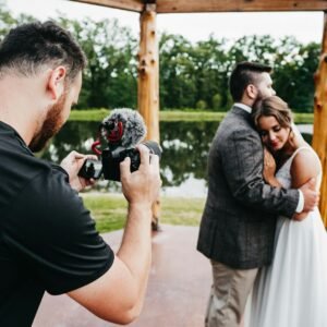 man in black t-shirt holding black dslr camera
